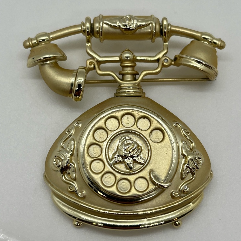 A Signed and Weighted Brushed Gold-Tone AJC Antique-Style Rotary Phone Brooch